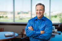 Home-Instead-Jeff-Huber-Franchisee-Satisfaction Home Instead's Jeff Huber Smiling in office in front of windows